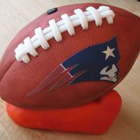 Football On Tee Pound cake with raspberry jam filling and covered in fondant. Tee is rice krispies treat covered in fondant (would do in colored solid...