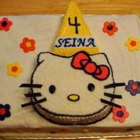 Hello Kitty Birthday Cake This is a sheet cake with Hello Kitty carved out of a 9" round. The party hat was cut from an 8" round. Fondant used for flower...