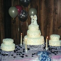 My Wedding Cake My wedding cake made by my Mom. Buttercream frosting with blue fondant flowers all over.