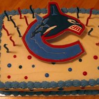 Canucks Cake Canucks cake for my son's 18th birthday. The cake is Swiss chocolate ice cream cake, whipped cream icing, and color flow logo and dots...