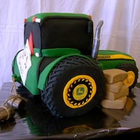John Deere Tractor The bride wanted to surprise her future husband with a cake to match his tractor. Tires are RKT and entire cake is covered in fondant.