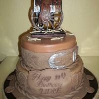 90Th Birthday - Western 8" and 10" cakes with buttercream frosting and fondant decorations to look like belts. The saddle on top was provided by the...