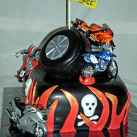 Motorcycle Cake Bottom tier is an 8" square that was rounded at the corners. Top "tires" are two 4" round cakes. Motorcycles are store...