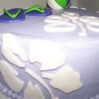 Beach Party Hibiscus purple buttercream with fondant hibiscus patterns, flip flops and beach ball