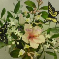 Chinese Inspired Spray Made entirely from gumpaste. Includes hibiscus, chinese jasmine, eucalyptus, honeysuckle and a couple of individually wired butterflies.