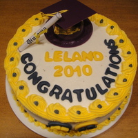 Lelands Graduation White cake colored Purple and Gold and BC frosting with fondant letters. The numbers are his football and basketball numbers which the...