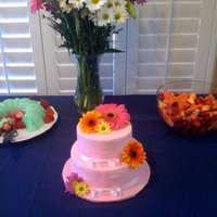 Pink Cake Covered In Sanding Sugar, Satin Ribbon And Fresh Flowers 