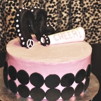 Pink, Girly Cheer Cake pink buttercream icing, fondant circles, gumpaste megaphone, and "M" was made out of cereal treats