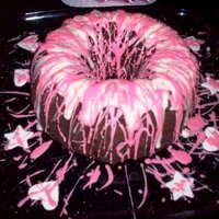 Pink Birthday Cake this chocolate cake was splattered with white chocolate and thinned and tinted buttercream icing. fondant stars and hearts surround cake.