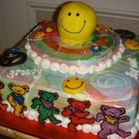 70's Cake Carrot cake with tie-dyed buttercream. Chocolate "dancing bears" happy faces and peace signs.