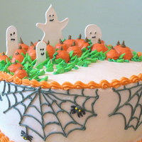 Ghosts In The Pumpkin Patch! This is a two-layer 9" cake frosted in BC of my own design that I made for my cake deco class. I made the ghosts out of royal icing...