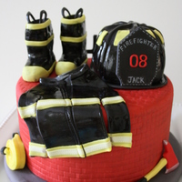 Firefighter Jacks Bday Cake My turned 8 this week and he wanted a firefighter themed cake. I decided to make a cake that had some of the things firefighters would use...