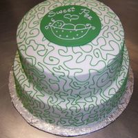 Sweet Pea Cake Buttercream frosting with colored buttercream piping. Cut fondant disc on top with (freehand) piping of sweet pea pod on top.
