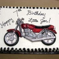 Motorcycle Cake I used a mold and fondant to create the motorcycle. The cake is iced with whipped icing.