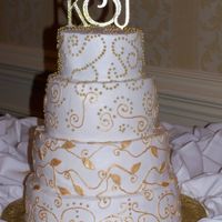 Gold & White Wedding Cake Buttercream frosting and piping - painted the piping with gold luster dust(!). The leaves are fondant, again painted with gold luster dust...