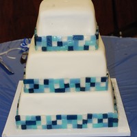 Blue Tile Mosaic Banana with strawberry filling and banana w/fudge filling, buttercream iced and MMF covered. Tiles were made of isomalt and attached with...