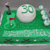 Mike's Golf Cake Yellow Sour Cream Cake W/ BC. I used the ball pan to make the big golf ball. The small balls are real practice balls and tees for the bday...