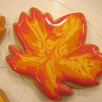 Autumn Leaves Iced in Royal Icing, starting with red around the edges, then orange and finally yellow in the center. Drag a toothpick around and you'...