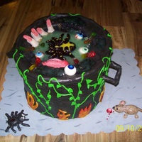 Gory Goulosh Black pot is cake covered with fondant,eyeballs,tongue,sewer rat and spider is made of fondant.The pot is piped with buttercream vines and...