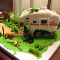 Camper Cake water tower with a campsite below full of all the camper experience