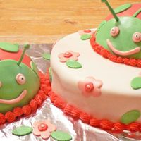 Ladybug Birthday Cake Pink and green ladybugs. Fondant with buttercream border.
