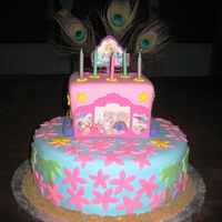 Barbie Island Princess Cake Two tiers almond cake covered in foundant. Sand is made with brown sugar.