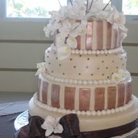 Ary's Cake Four tier, almond and chocolate cake. All covered in foundant and decorated with orchids, cala lillies.