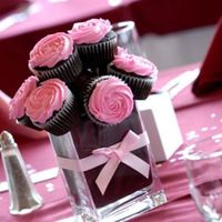 Cupcake Bouquet Reception Centerpieces I did these for a bride that couldnt think of unique centerpieces. They are square glass vases with rectangle cut green foam wrapped in...