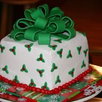 Christmas Cake I made this cake for our Christmas get together with friends. I used my new plunger cutters for the holly on the cake. Fondant bow.