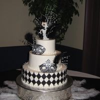 Masquerade Wedding Three tiered buttercream iced cake with fondant masks and harlequin pattern. The masks were actually exact replicas of the masks the bride...