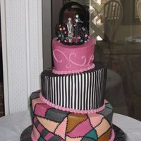 A Nightmare Before Christmas Buttercream iced topsy turvy cake with Jack and Sally figures on top. I made the archway out black pipe-cleaners wrapped around heavier...