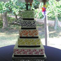 Bobble Head Cake Five tiered, square cake, edged with black ribbon. Each layer's color of decorations represented a bridal attendant's dress color...