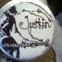 Guitar Player one of four 6 inch cakes i did that day. this one is chocolate with buttercream icing with chocolate guitar player and writing.