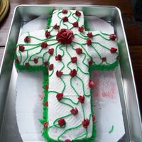 Cross With Roses Red velvet cake with buttercream icing and roses. I carved the cross out of the 11x13 pan it's pictured in.