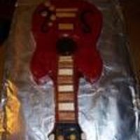 Guitar Cake Chocolate cake with chocolate filling and icing. Decorated with fondant and hand painted to look like my husband's weird guitar. Sorry...