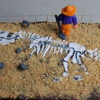 Bones, Bones, Dinosaur Bones THis cake is based on the book-Bones, Bones, Dinosaur Bones. THe man, rocks, shovel, and dinosaur are fondant.