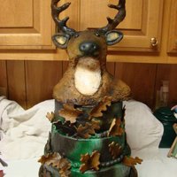 Three Tier Camouflage Buck Cake Three tier airbrushed camouflage cake topped with a buck made of rice krispy treats covered in fondant then airbrushed. I was extremely...