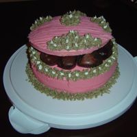 Box O' Chocolates Lemon cake with lemon filling. Iced wit pink and green butter icing. Topped off with a yummy chocolates. Thanks for looking!