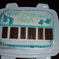 Keyboard Cake Eggless Chocolate Cake with butter icing. White chocolate melted with a tint of blue and KitKat for the keyboard keys. Thanks for looking...