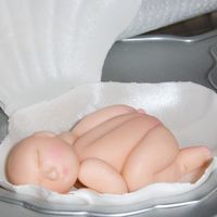 Baby Aaliyah Sleeping In Her Shell Cradle I made the shell from gum paste and the baby from fondant. I put these on the shower cake I made for my daughter-in-law's shower.