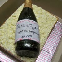 Happy 50Th cake is key-lime with key-lime buttercream, champagne bottle made of gumpaste molded over an actual bottle, crate is fondant with white...