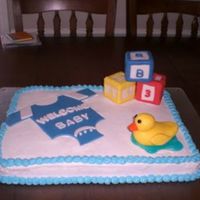 Baby Shower Cake BC with fondant accents. baby blocks are make with rice crispy treats. ducky is all fondant & water is piping gel tinted blue.