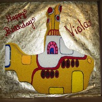 Yellow Submarine birthday cake of the Beatles Yellow Submarine. Sub was carved out of a sheet cake and covered entirely in buttercream using different size...