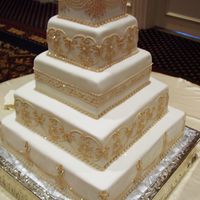 Gold Sparkles The bride wanted a gold sparkly cake. So, I did all the piping work in a dark ivory and while the frosting was still wet, I sprinkled gold...