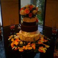 Frist Wedding Cake The bottom 2 layers are dummies the top is a yellow cake w/ BC filling. It is all covered in fondant. Off white and chocolate with ribbons...