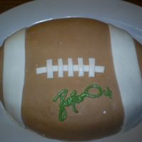 Autographed Ball The hubby said he wanted an autographed football by Brett Favre for his birthday... so I made him this :) Lemon cake with whipped cream...