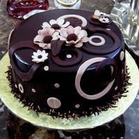 Chocolate & Bees This is a Chocolate Cake with Chocolate Ganache and apricot filling, Flowers were made with Gumpaste and several different cuts of circles...