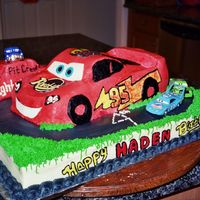 Lighting Mcqueen Racing Used Wilton Car pan and added ricecrispy treats to help shape car on top of a sheet cake. Buttercream with some fondant accents. The 4...