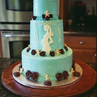 Pregnant Lady Blues 10, 6, 3 inch cakes stacked, covered in buttercream with chocolate royal icing roses and fondant silhouette. Chocolate cake with semisweet...