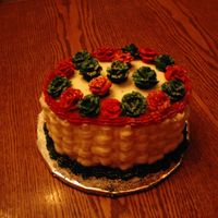 Christmas Cake 2006 8 in oval, basketweaved, buttercream cake with green and red roses.